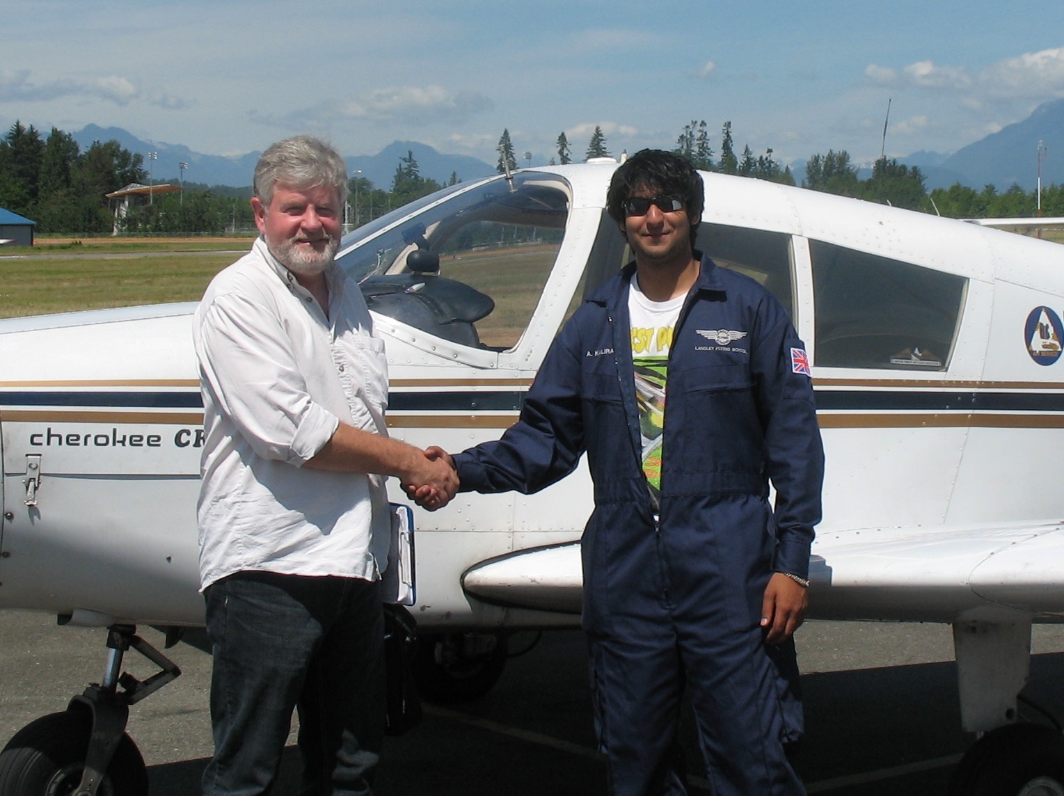 Andy Kalirai receives congratulations form Pilot Examiner Paul Harris after the successful completion of Andy's Private Pilot Flight Test on July 28, 2008. Langley Flying School.